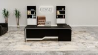 A sleek and modern executive office desk made from rich, dark wood with a spacious desktop.